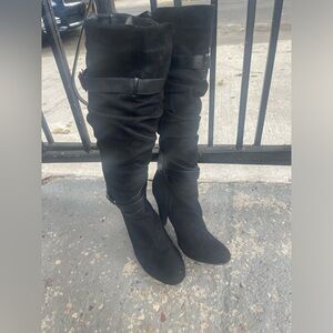 Black knee high heeled boots